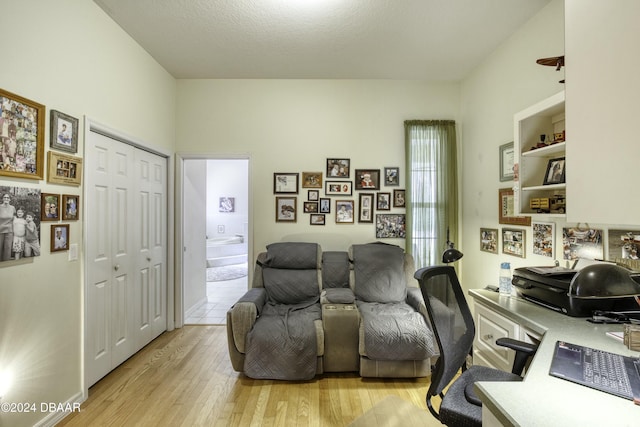 office space with light hardwood / wood-style flooring and a textured ceiling