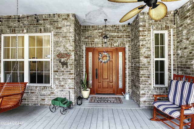 view of exterior entry featuring ceiling fan