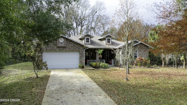 view of front of house with a front yard, a porch, and a garage