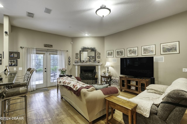 living room featuring french doors and hardwood / wood-style flooring