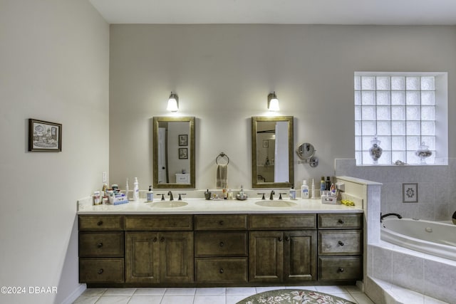 bathroom with tile patterned floors, vanity, and tiled tub