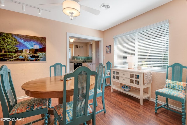 dining space featuring ceiling fan, wood-type flooring, and track lighting