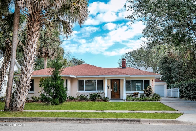 ranch-style home with a front lawn and a garage