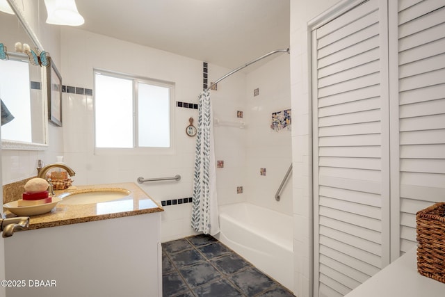 bathroom with tile walls, vanity, and shower / bathtub combination with curtain