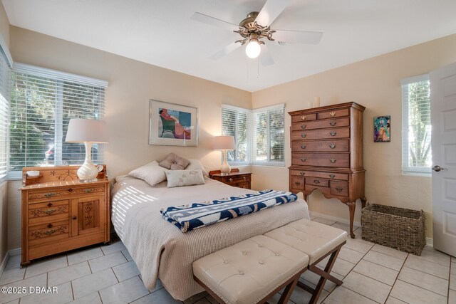 bedroom with ceiling fan and light tile patterned floors