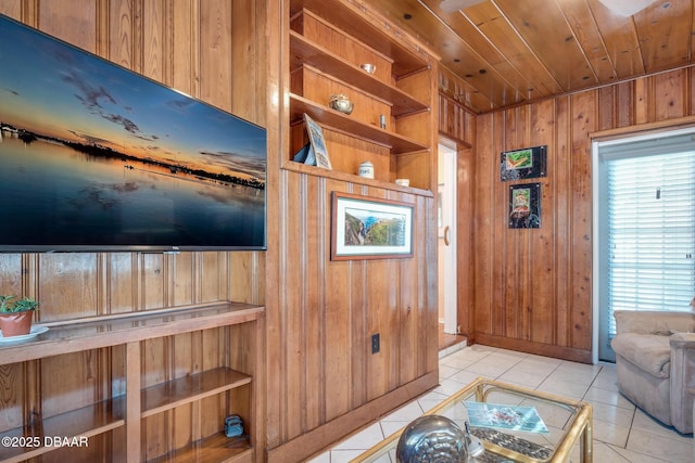 living room with light tile patterned flooring, wood ceiling, and wooden walls