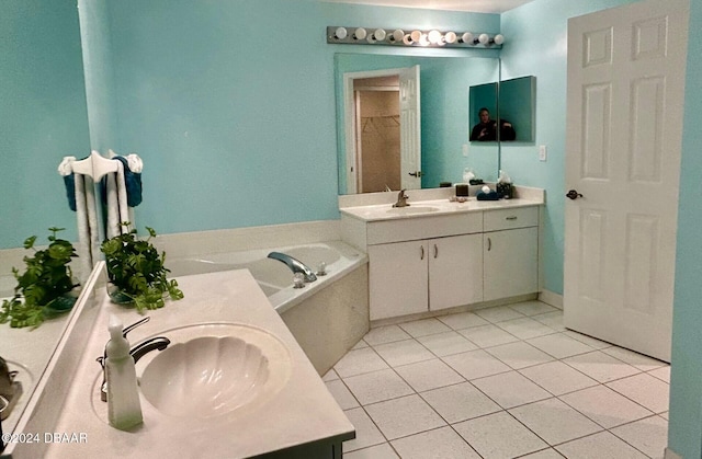 bathroom featuring a bathtub, tile patterned flooring, and vanity