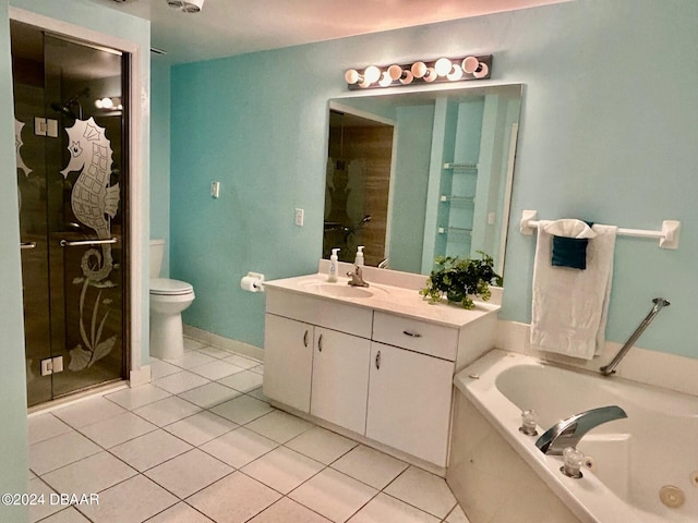 bathroom with tile patterned flooring, vanity, a relaxing tiled tub, and toilet