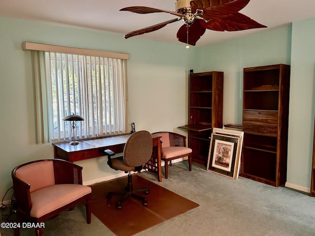 carpeted office space with ceiling fan