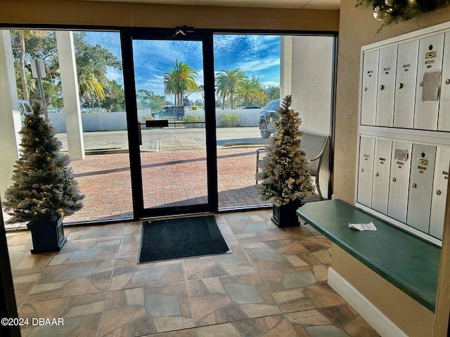 entryway with a wealth of natural light and a mail area