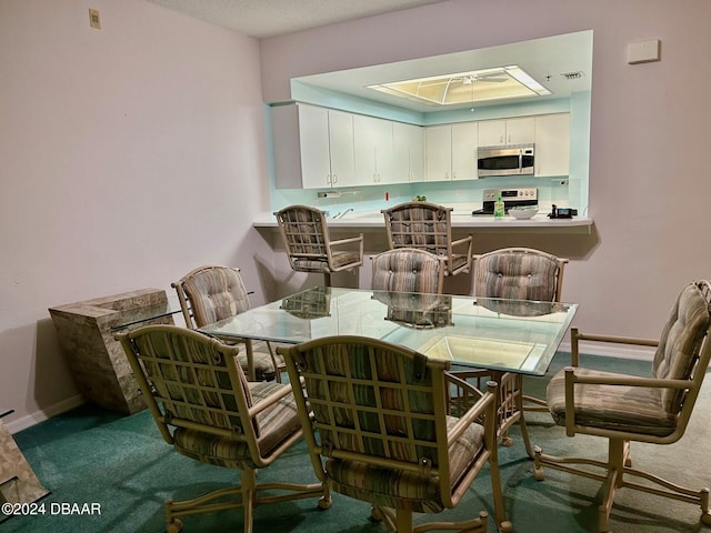 carpeted dining area featuring a raised ceiling