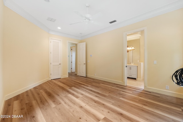 empty room featuring light wood-type flooring, ceiling fan, and crown molding