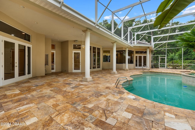 view of swimming pool featuring a patio area, a lanai, and ceiling fan