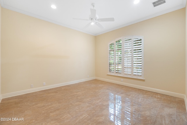 spare room with light tile patterned floors, ceiling fan, and crown molding