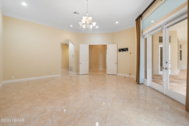 unfurnished room with crown molding and a notable chandelier