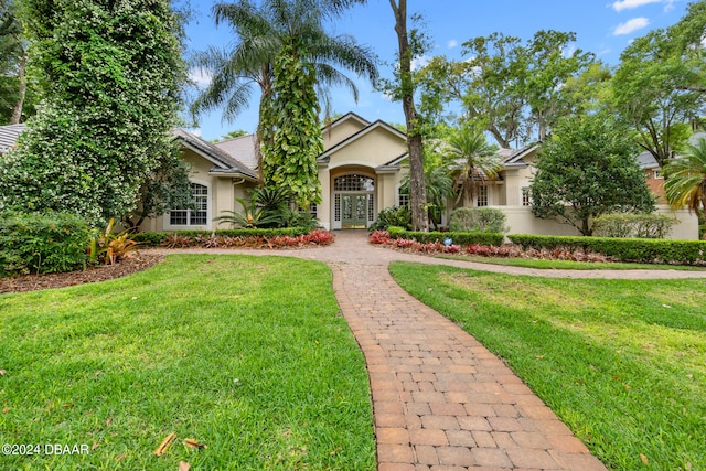 view of front of house with a front yard and french doors