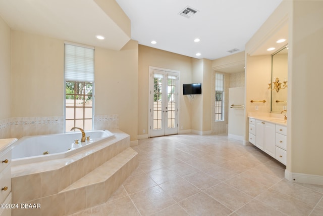 bathroom featuring french doors, vanity, tile patterned floors, and a relaxing tiled tub