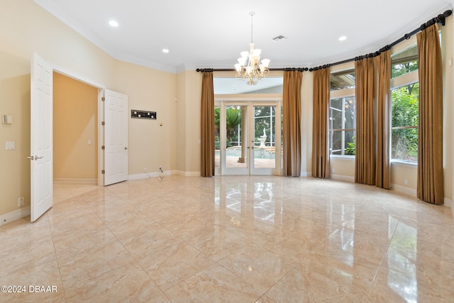 unfurnished room featuring french doors, a notable chandelier, and crown molding