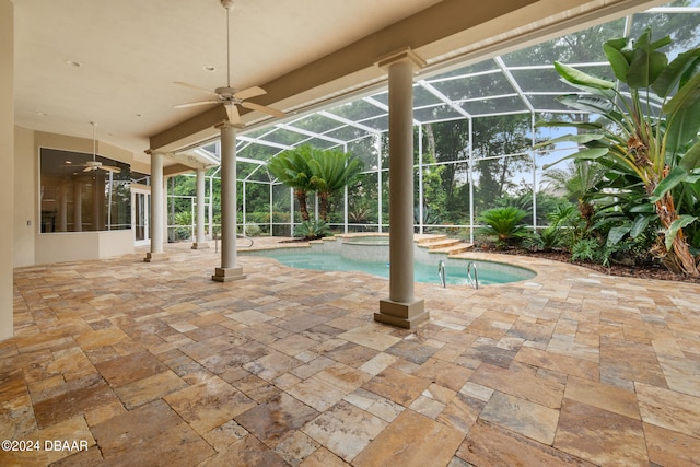 view of pool with ceiling fan, glass enclosure, and a patio area