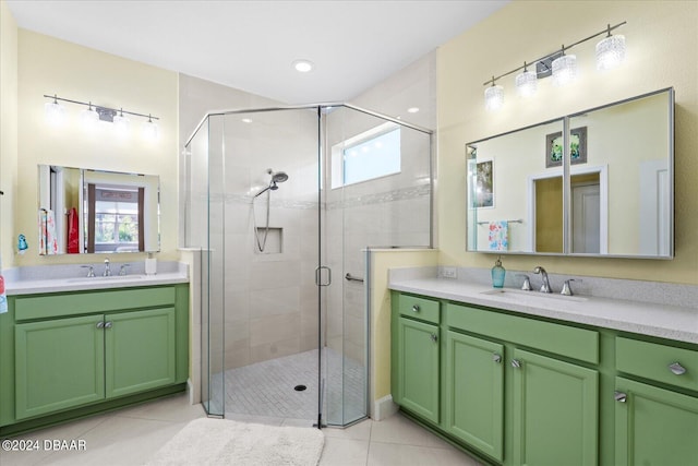 bathroom featuring tile patterned flooring, vanity, and a shower with shower door