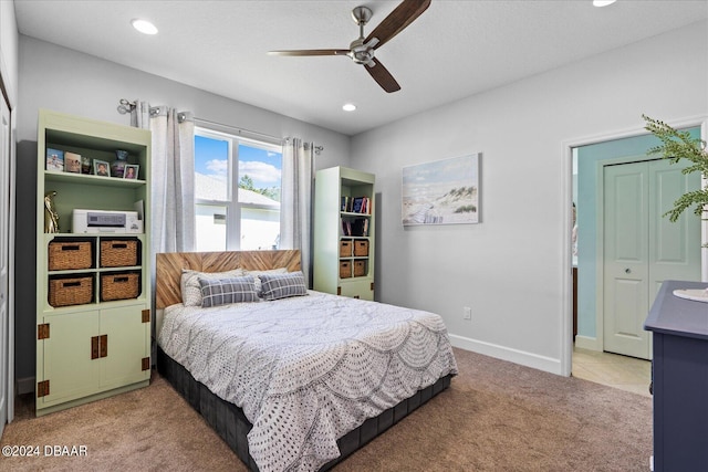 carpeted bedroom featuring a closet and ceiling fan