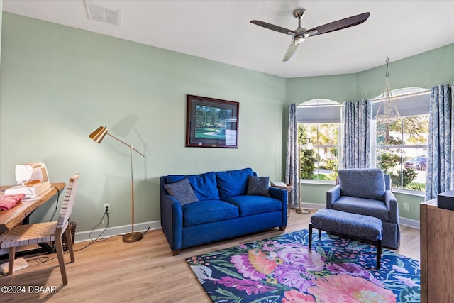 living room featuring light hardwood / wood-style floors and ceiling fan