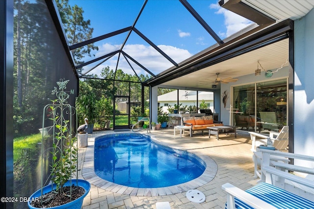 view of pool featuring ceiling fan, a patio, a lanai, and an outdoor hangout area