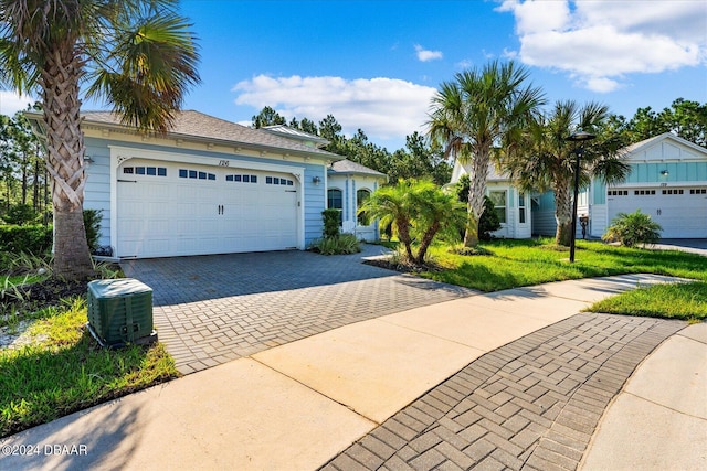 single story home with a garage and a front yard