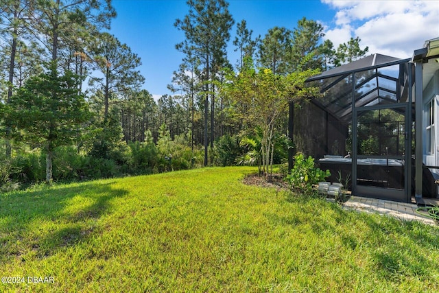 view of yard with glass enclosure