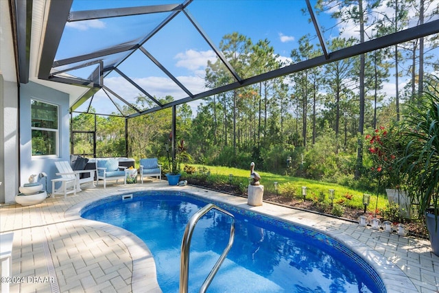 view of pool featuring a patio area, glass enclosure, and an outdoor hangout area