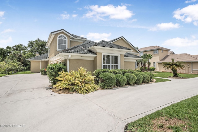 1766 Roscoe Turner Trl, Port Orange, FL 32128 - view of front of home featuring stucco siding, concrete driveway, and a tiled roof