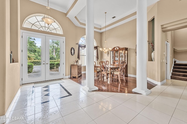 1766 Roscoe Turner Trl, Port Orange, FL 32128 - foyer entrance featuring ornate columns, crown molding, tile patterned floors, baseboards, and a high ceiling