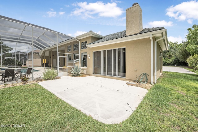 1766 Roscoe Turner Trl, Port Orange, FL 32128 - rear view of house with a patio area, a chimney, a lawn, and a tiled roof