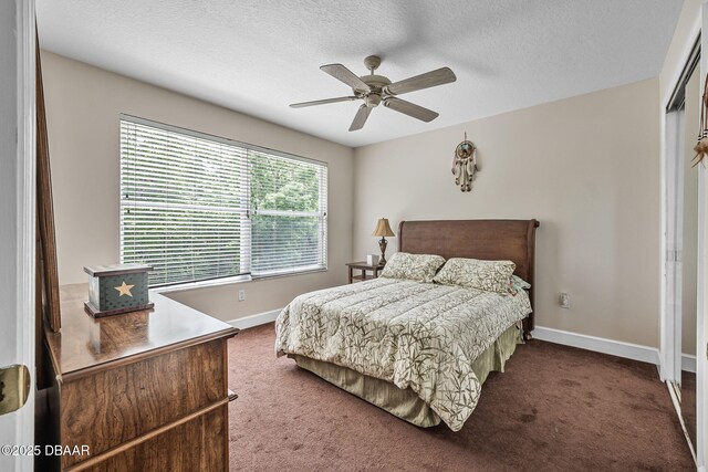 1766 Roscoe Turner Trl, Port Orange, FL 32128 - bedroom featuring carpet floors, baseboards, a textured ceiling, a closet, and a ceiling fan