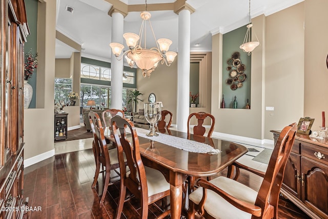 1766 Roscoe Turner Trl, Port Orange, FL 32128 - dining area with ornate columns, crown molding, a chandelier, baseboards, and dark wood-type flooring