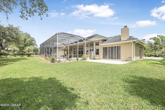 1766 Roscoe Turner Trl, Port Orange, FL 32128 - back of property with a chimney, a lawn, stucco siding, a patio, and glass enclosure