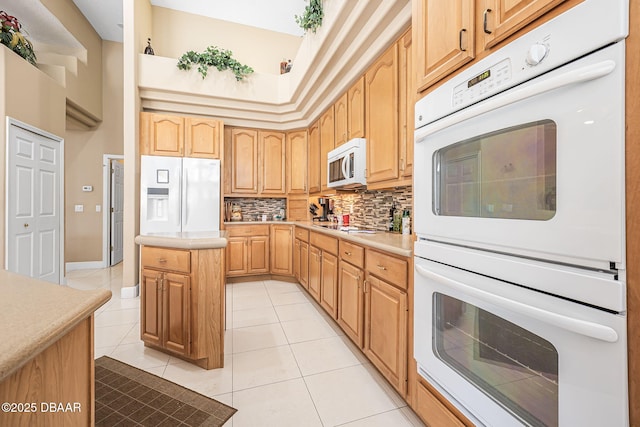 1766 Roscoe Turner Trl, Port Orange, FL 32128 - kitchen with white appliances, tasteful backsplash, light tile patterned floors, light countertops, and a kitchen island