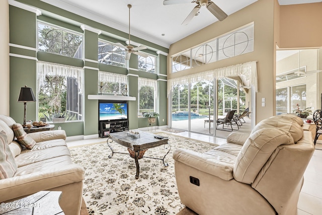 1766 Roscoe Turner Trl, Port Orange, FL 32128 - living area featuring ceiling fan, a towering ceiling, tile patterned flooring, and baseboards