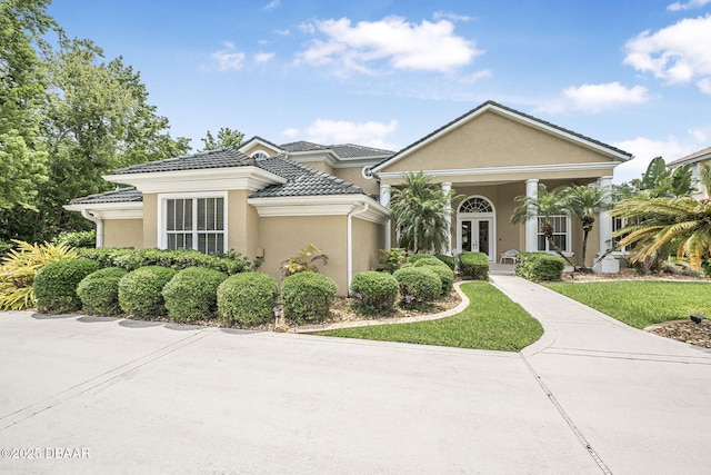 1766 Roscoe Turner Trl, Port Orange, FL 32128 - view of front facade with stucco siding, french doors, and a tiled roof