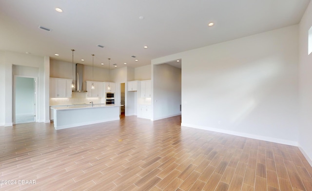 unfurnished living room with light wood-type flooring