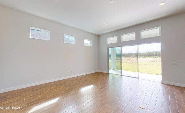 spare room with light hardwood / wood-style flooring