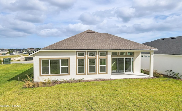 back of property with a patio area and a yard