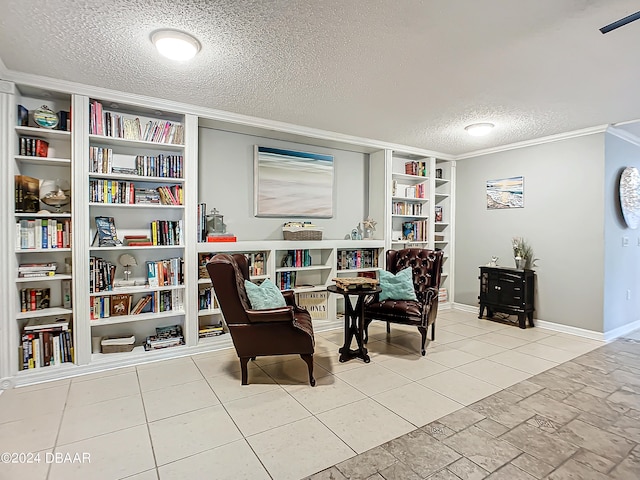 sitting room featuring a textured ceiling, light tile patterned floors, and crown molding