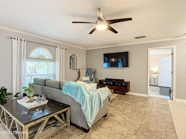 living room with a textured ceiling, ceiling fan, and crown molding