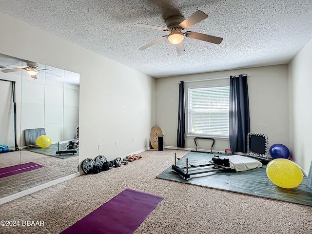 workout area with carpet flooring, a textured ceiling, and ceiling fan