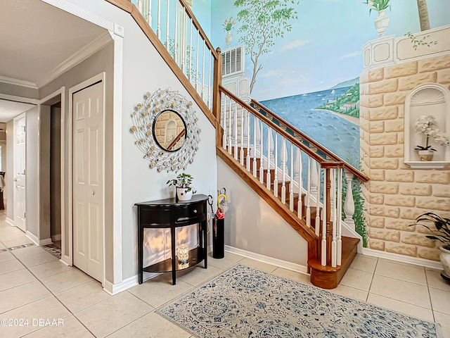 staircase featuring tile patterned floors and ornamental molding