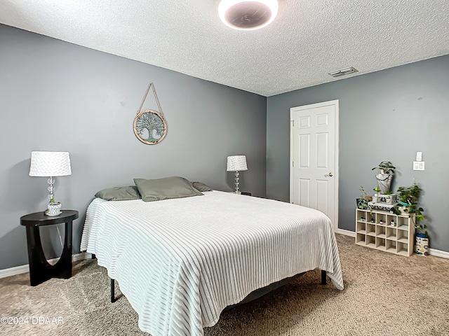 carpeted bedroom with a textured ceiling