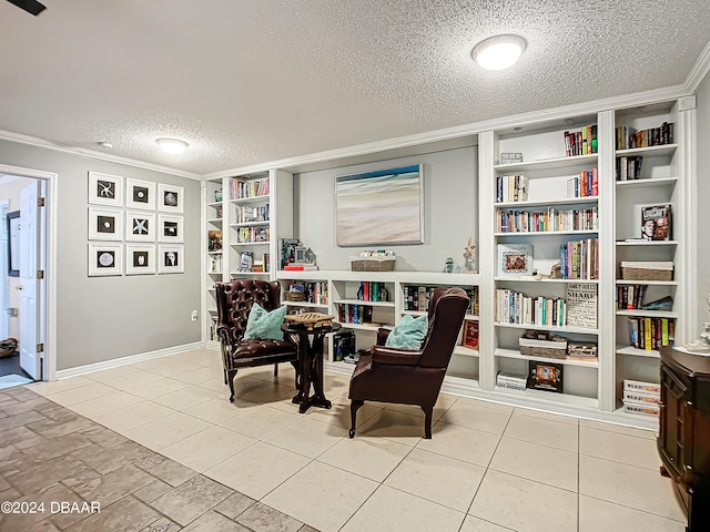 sitting room with built in shelves, a textured ceiling, crown molding, and light tile patterned flooring