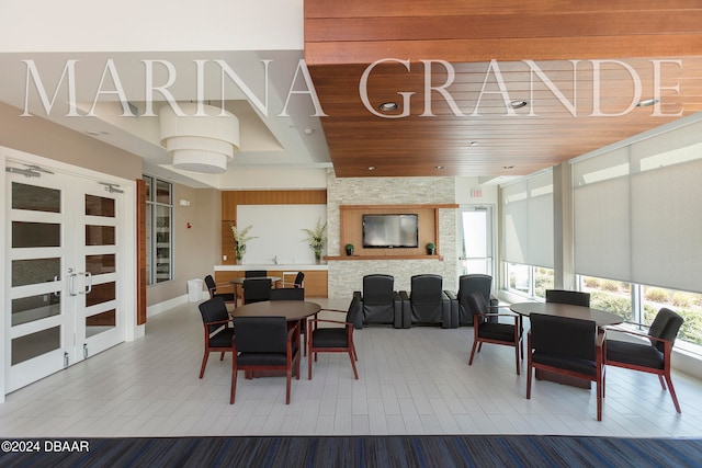 dining room with french doors, hardwood / wood-style floors, and wooden ceiling