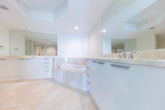 bathroom with plus walk in shower, vanity, and tile patterned flooring